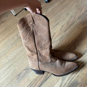 Brown suede cowboy boots.